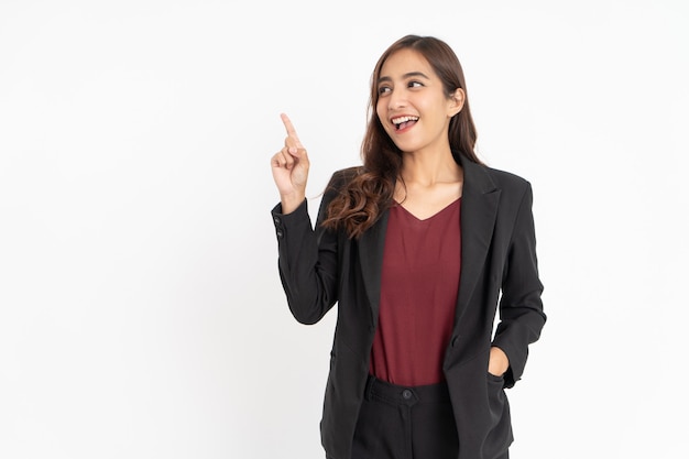 Excited young businesswoman with hand gesture pointing sideways with copyspace