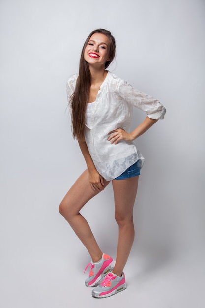 Excited young casual girl having fun. Isolated on white background.