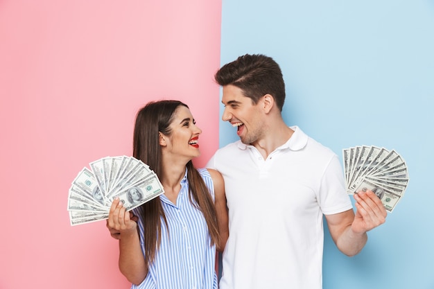 Photo excited young couple standing isolated