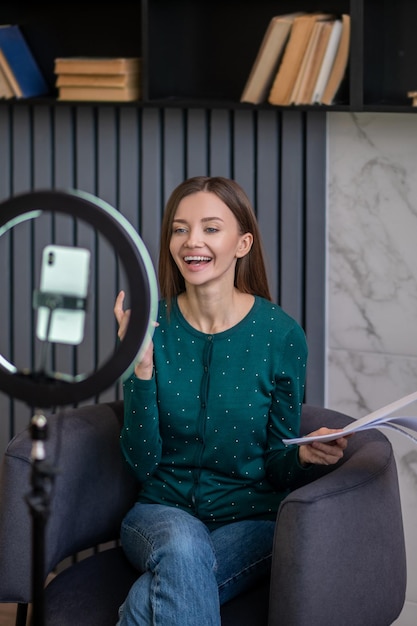 Excited young woman conducting an online tutorial