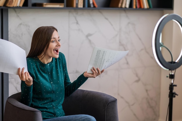 Excited young woman conducting an online tutorial