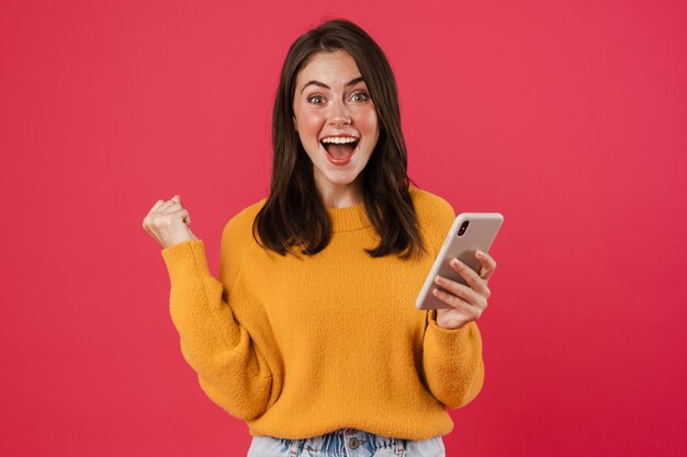 Excited Young Woman Holding Mobile Phone