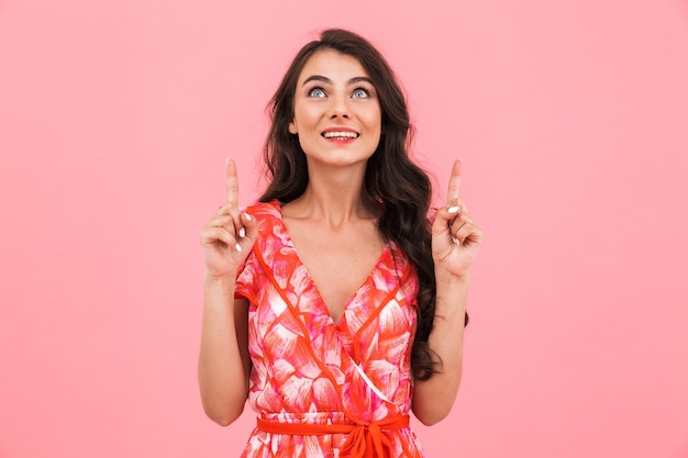 Excited young woman posing isolated wall pointing.