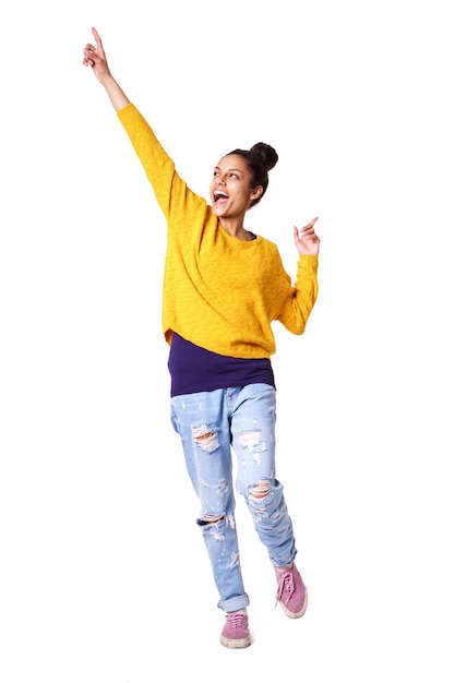 Excited young woman standing with her arms up 