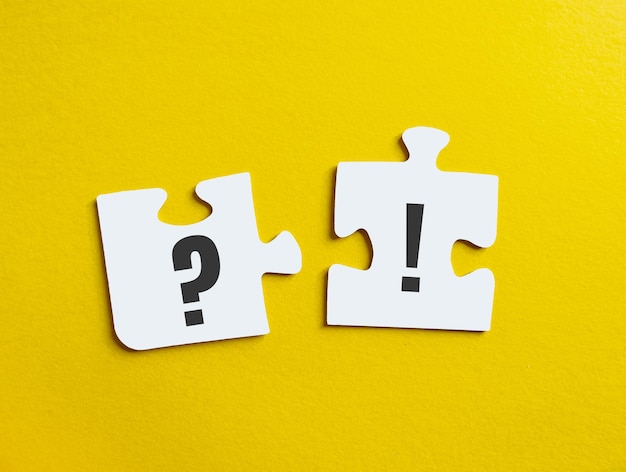 Exclamation point and question mark on puzzle on yellow background concept of information guide questions and answers faq section for banner poster