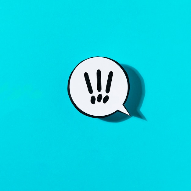exclamatory mark on white speech bubble against blue background