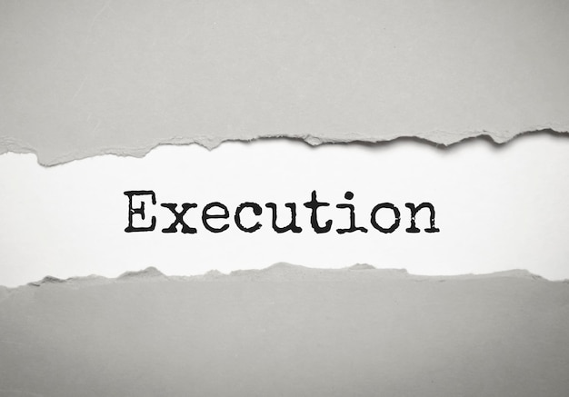 Execution word on the torn paper Business concept