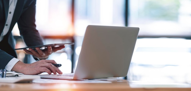 Executive businessman working on laptop computer at modern workspace