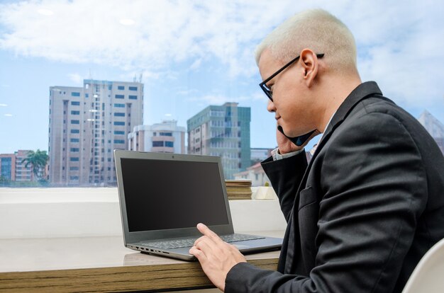 Executive man checking computer near window