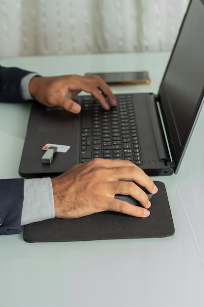 Executive man looking and typing on a computer