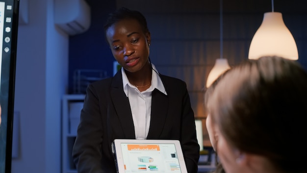 Executive manager black woman working in office meeting room explaining company management statistics