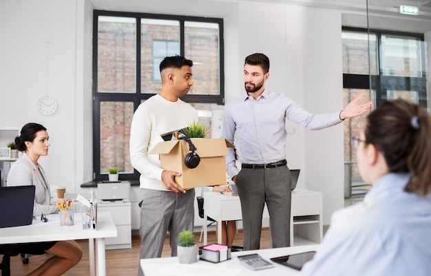 executive seeing off sad fired male office worker