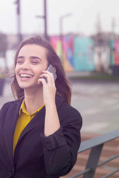 Executive working with a mobile phone in the street