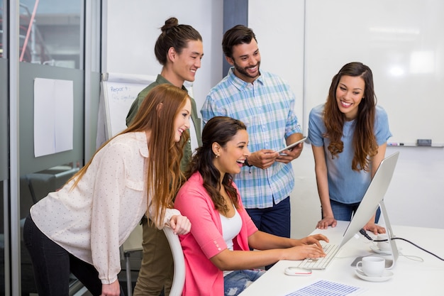 Executives discussing over computer in conference room