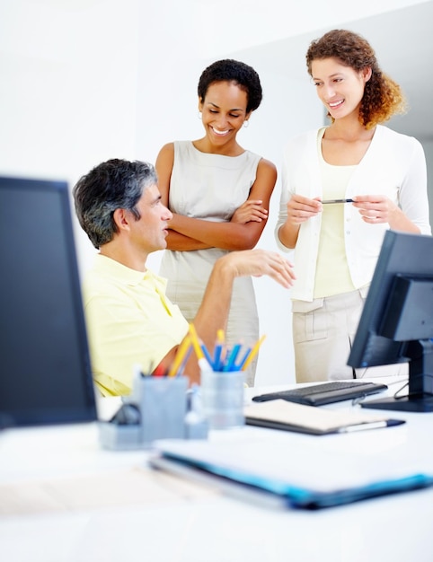 Executives discussing male executive sitting at table and discussing work with female colleagues