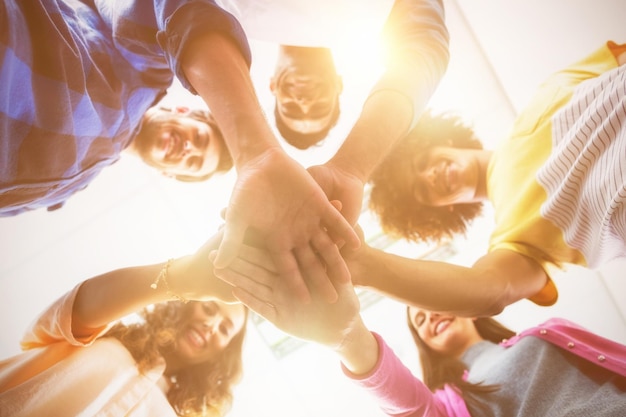 Executives forming hands stack at office