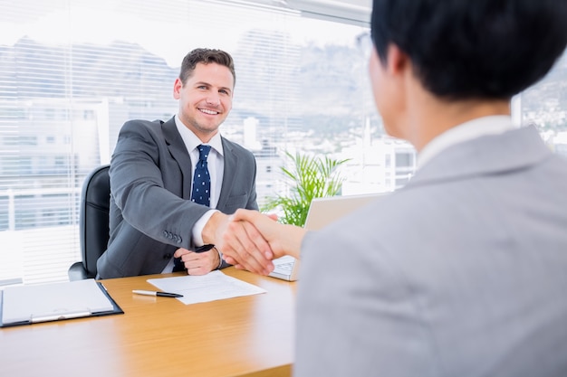 Executives shaking hands after a business meeting