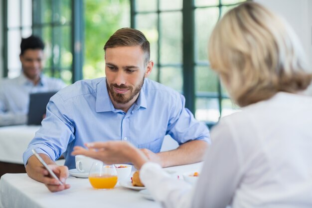 Executives using mobile phone in a restaurant