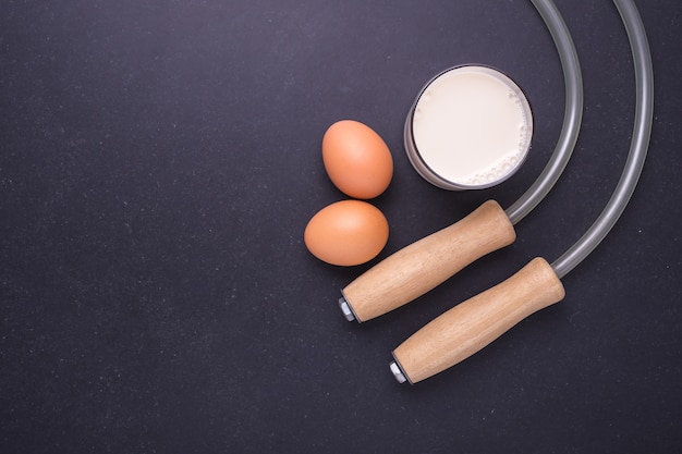 Exercise Concept: Top view skipping rope on black stone table background