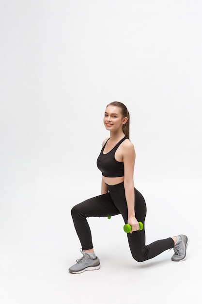 Exercise. Sports Woman In Fashion Sportswear Stretching Legs.