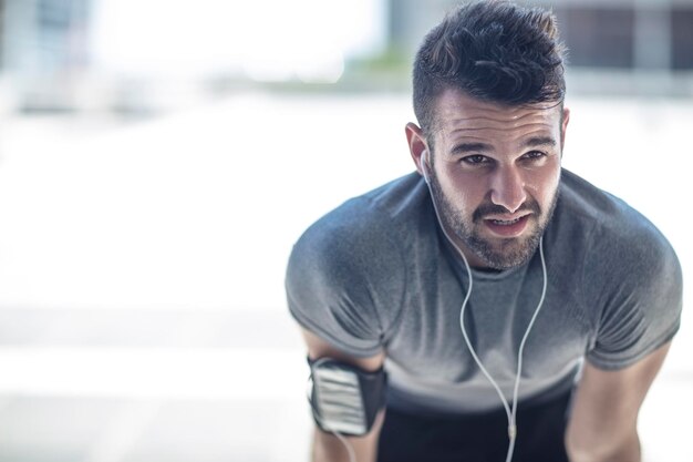 Exhausted athlete taking a break in the city