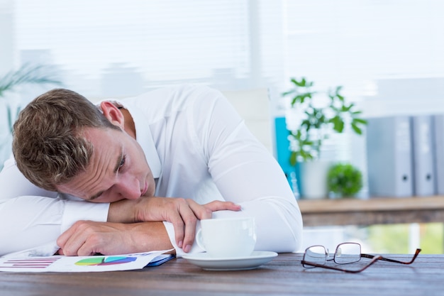 Exhausted businessman sleeping on the desk