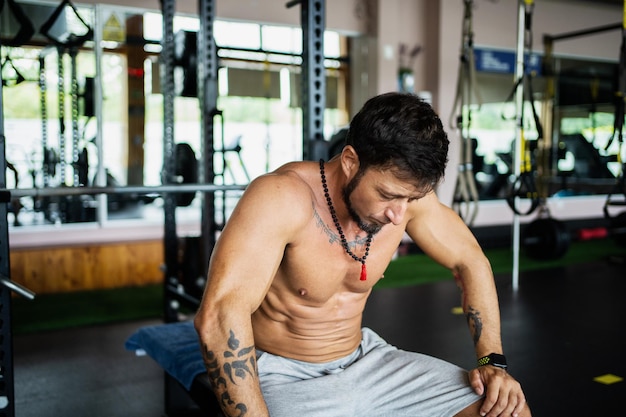 Exhausted man sitting on a gym