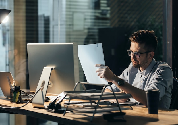 Exhausted man with papers overworking