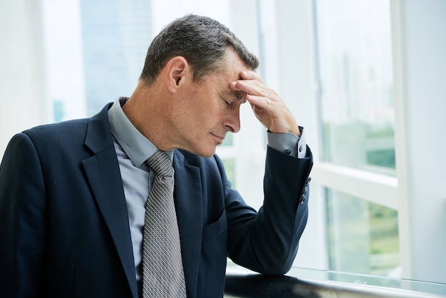 Exhausted Mature Businessman At Office