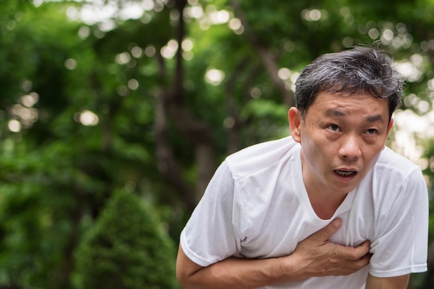 Exhausted panting cardiac arrest running senior man outdoor park