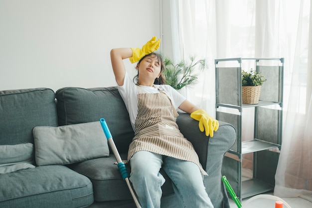 Photo exhausted woman resting after cleaning home