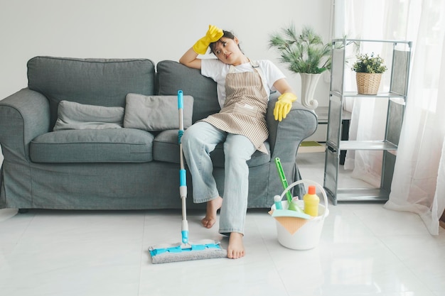 Photo exhausted woman resting after cleaning home