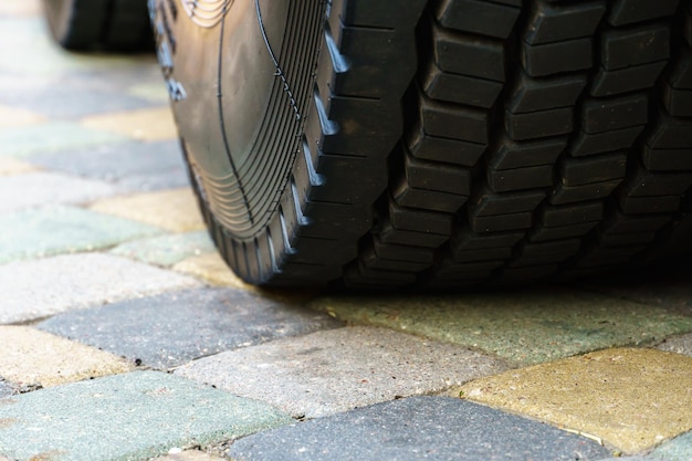 Exhibition of new largesized equipment cars for cargo\
transportation big black truck tire closeup equipment for working\
in a quarry