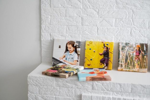 a exhibition of photos, photocanvases, active little girl