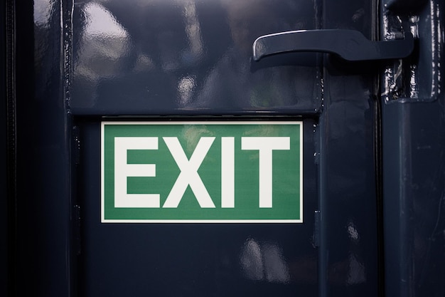 Photo exit sign on black metal door