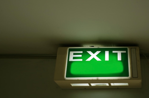 Exit sign hanging on the ceiling with copy space