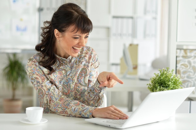 Exited woman with laptop