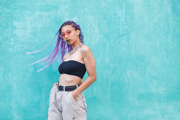 Exotic black woman with casual clothes isolated on a green wall