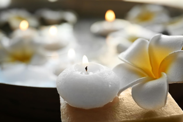 Photo exotic flower and candle with soap close up