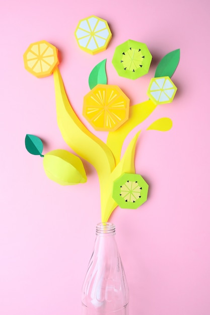 Exotic fruits made of paper on pink background