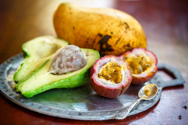 Exotic fruits on a plate on a concrete table