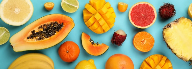 Exotic fruits set on blue background, top view.