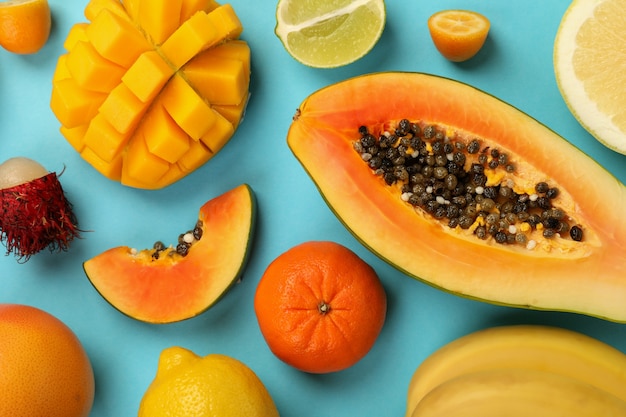 Exotic fruits set on blue background, top view.