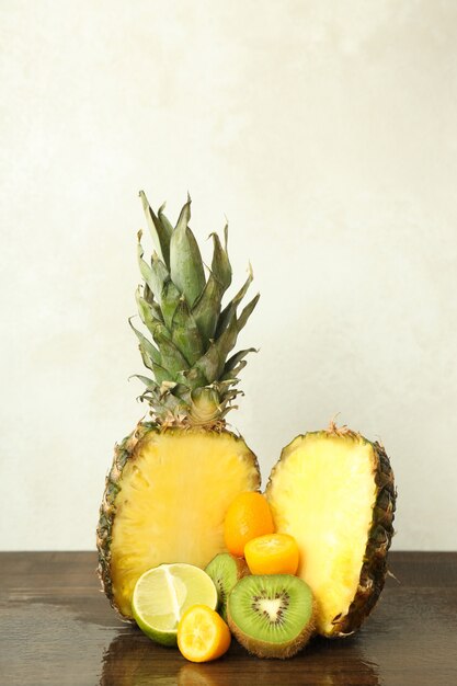 Exotic fruits on wooden table against white background.