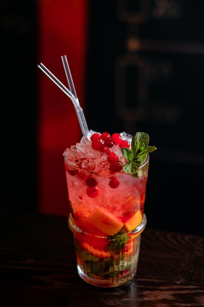 Exotic tropical cocktail with cherry and lemon on the bar counter