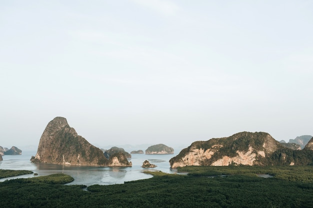 Exotic and tropical dark green islands with rocks, blue sea and clear sky at Ao Phang-nga National Park