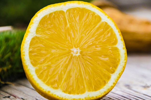 Exotic tropical fruits, citrus backgrounds and detailed foods\
textures concept with full frame photograph of extreme macro close\
up on a slice of lemon with high contrast dramatic light