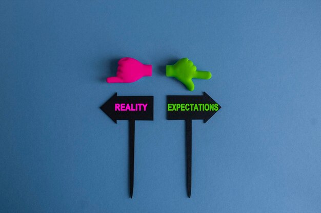 Expectations or reality symbol BLACK ARROWSHAPED PLAQUES WITH THE WORDS