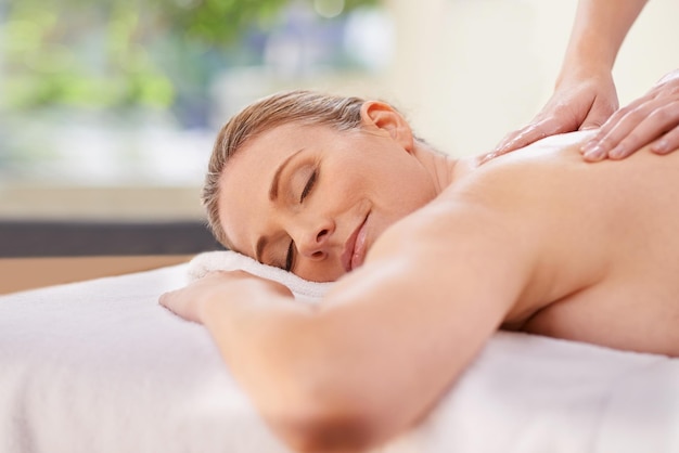 Experience total bliss Cropped shot of a woman in a day spa relaxing on a massage table