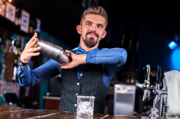 Experienced bartender formulates a cocktail